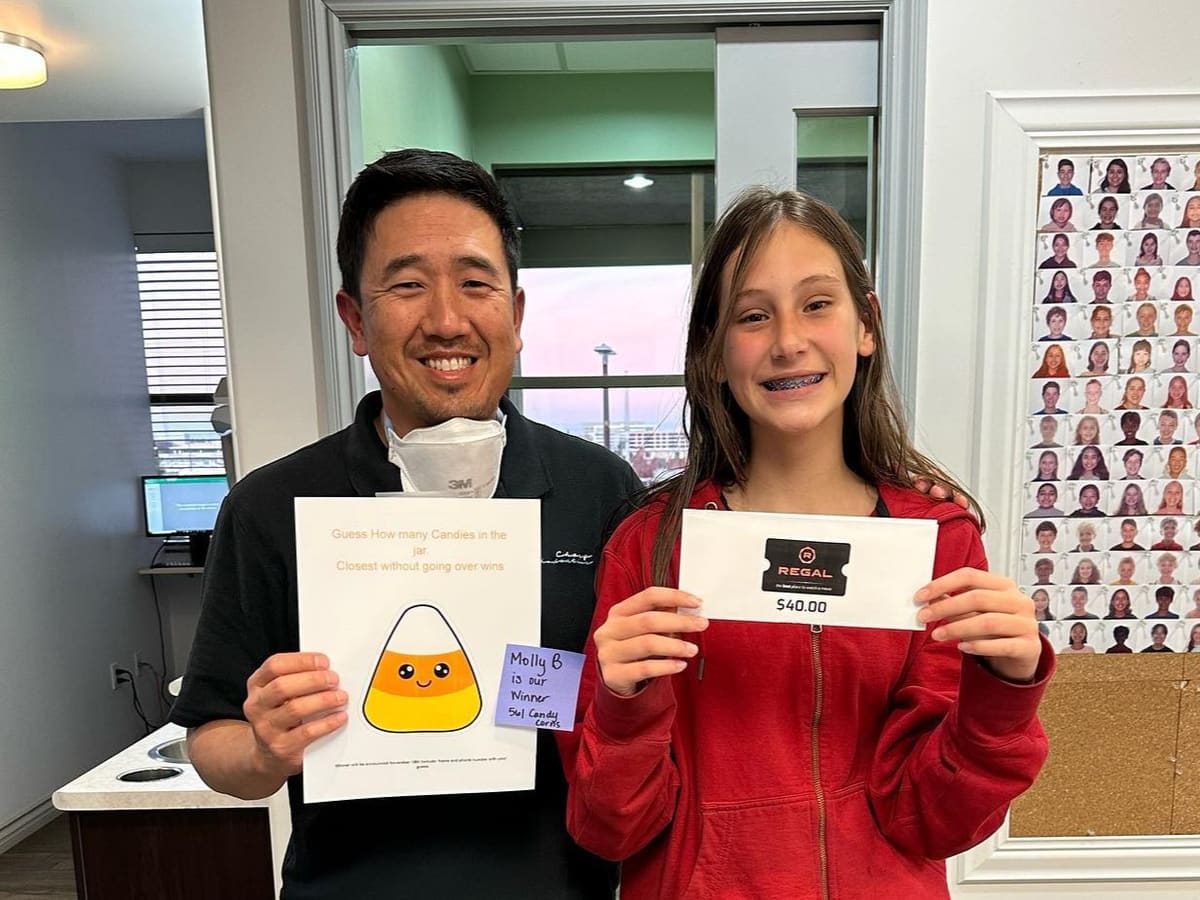 Dr. Chang celebrating with a young patient at Chang Orthodontics