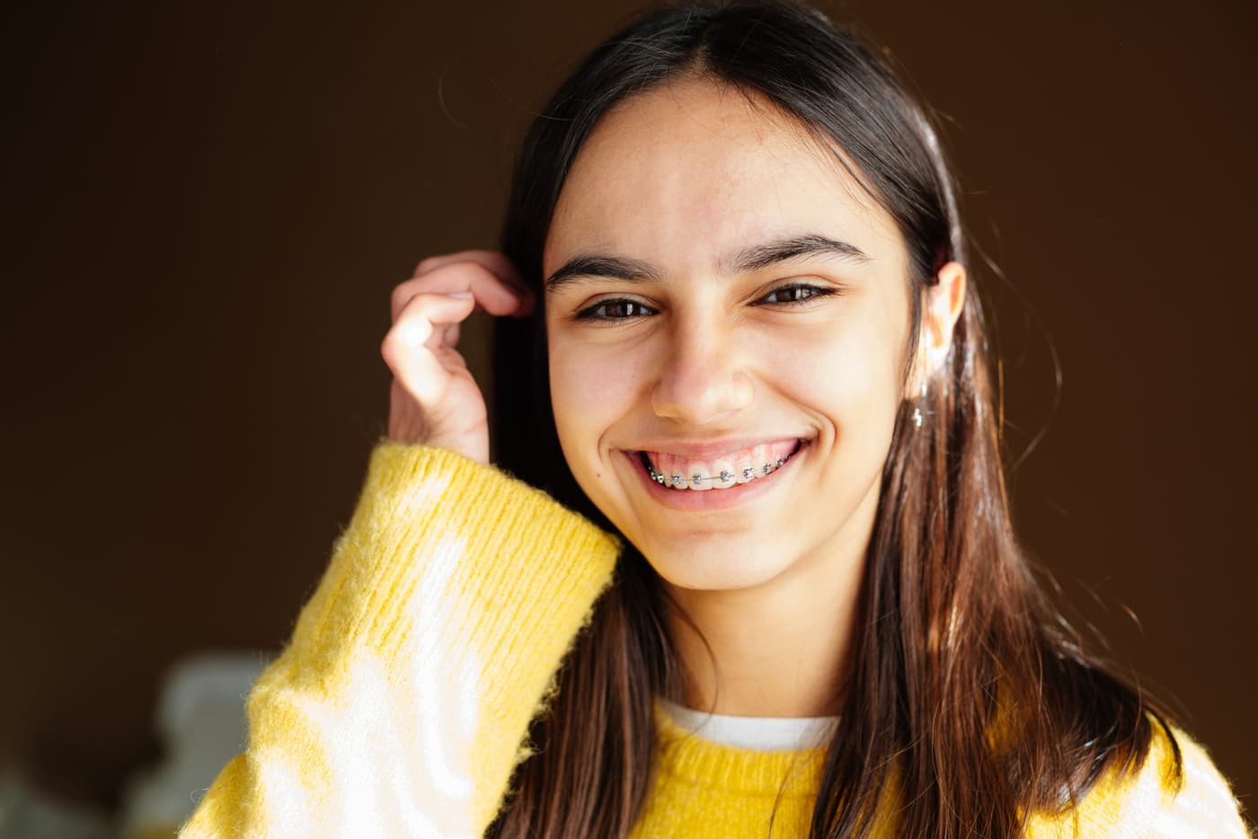 A teenager with braces laughing