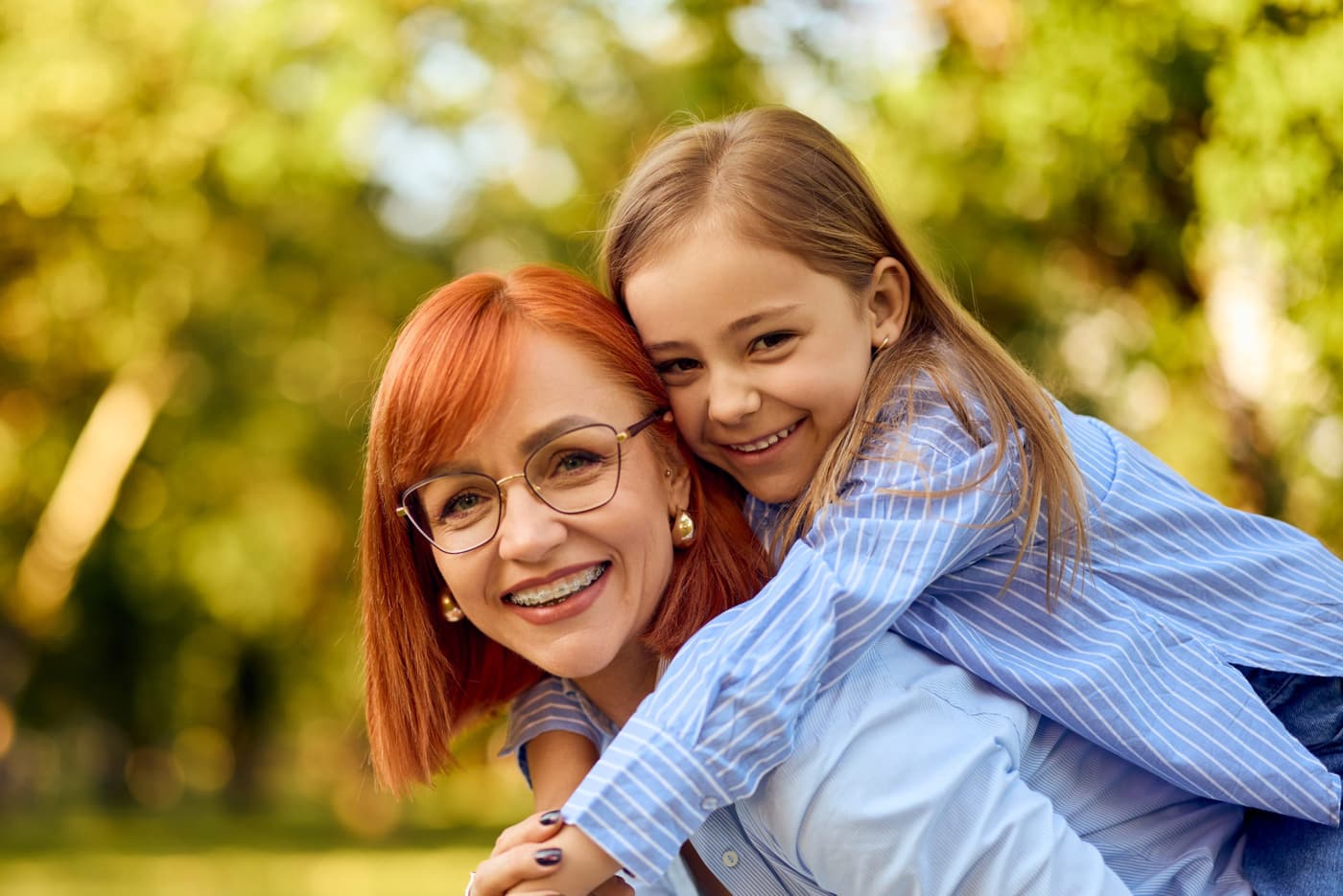 A mother and daughter smiling at the orthodontist